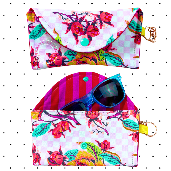 A multicolored floral sunglasses case with a snap closure and a keychain attachment.