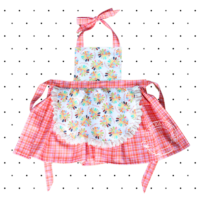 Image is of the childs apron, orange and white.